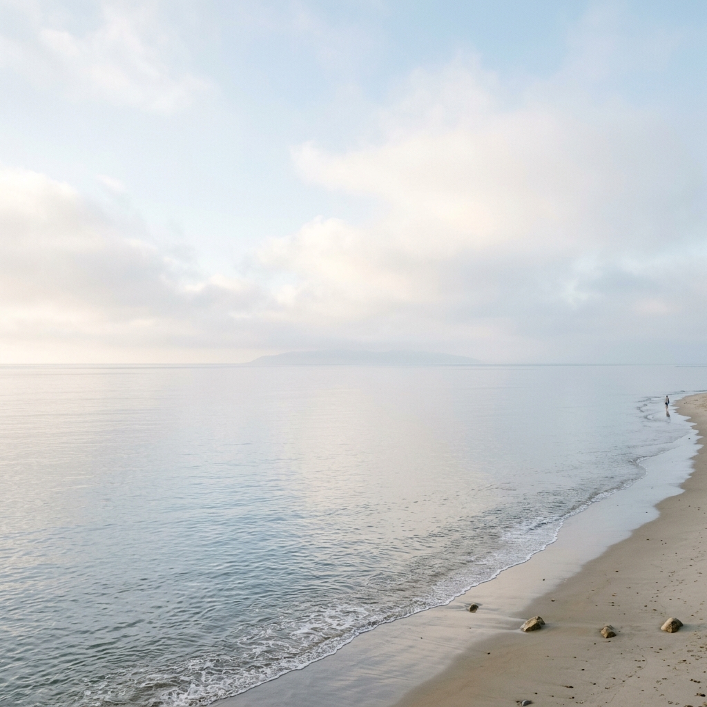 A calm and peaceful ocean horizon in Southern California under a soft morning mist