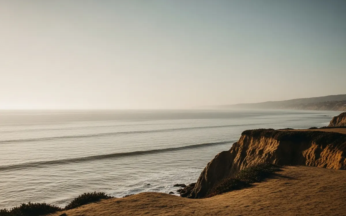 Calm coastal bluff and open ocean horizon near Del Mar under soft morning light with wide sky