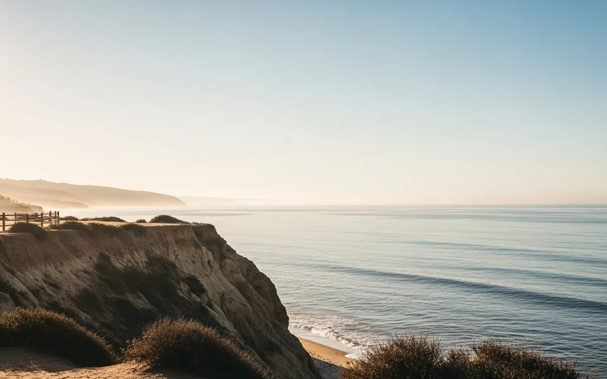 Calm North County San Diego coastal bluff and open ocean under soft morning light with wide sky