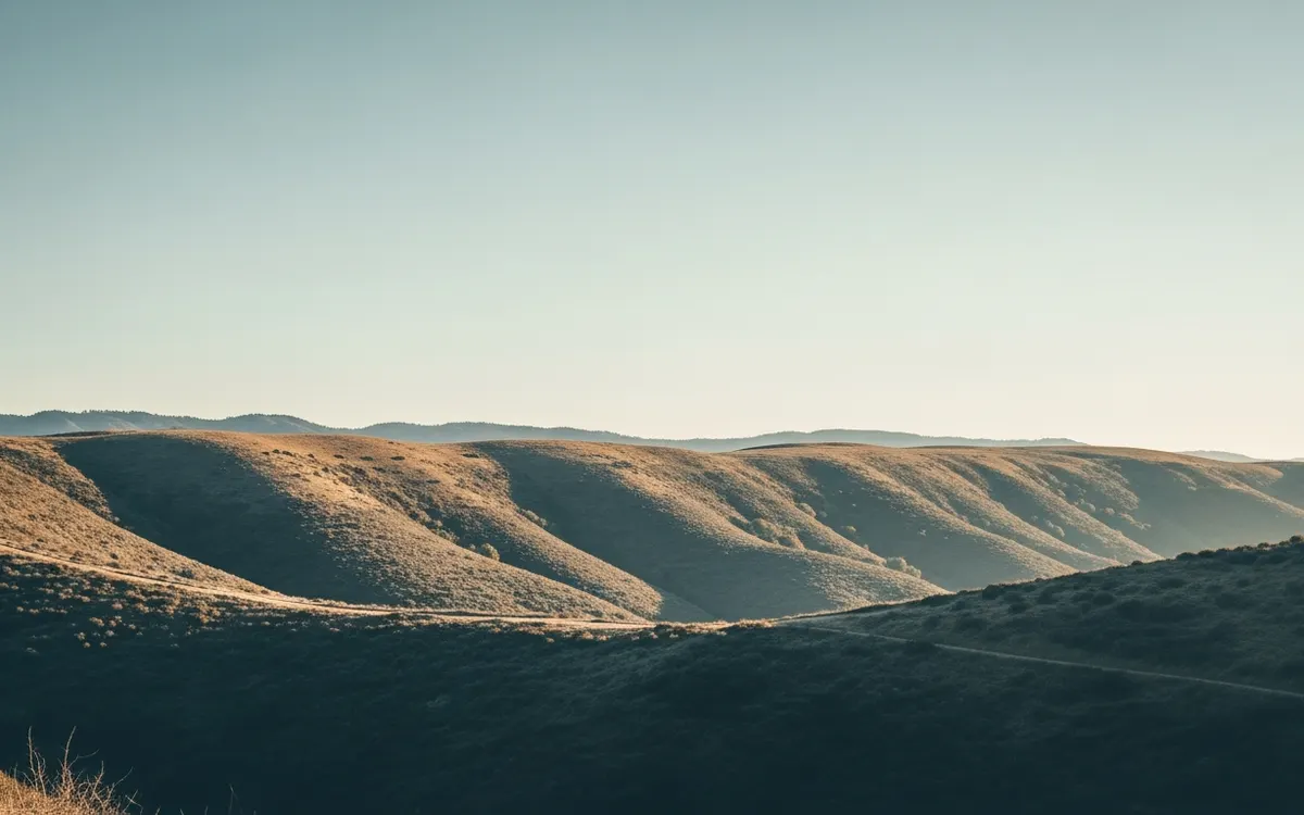 Calm East County hillside and open canyon ridgeline near La Mesa under soft morning light with wide sky