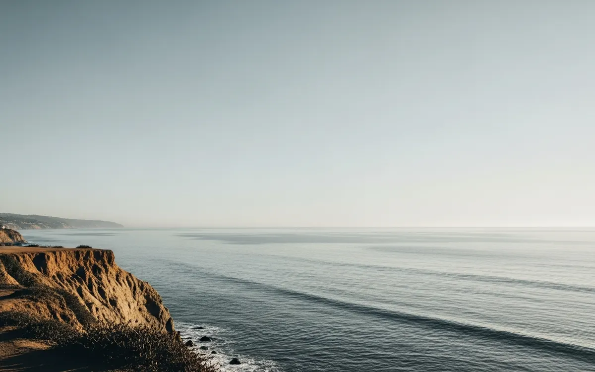 Calm coastal bluff and open Pacific horizon near Santa Monica under soft morning light with wide sky
