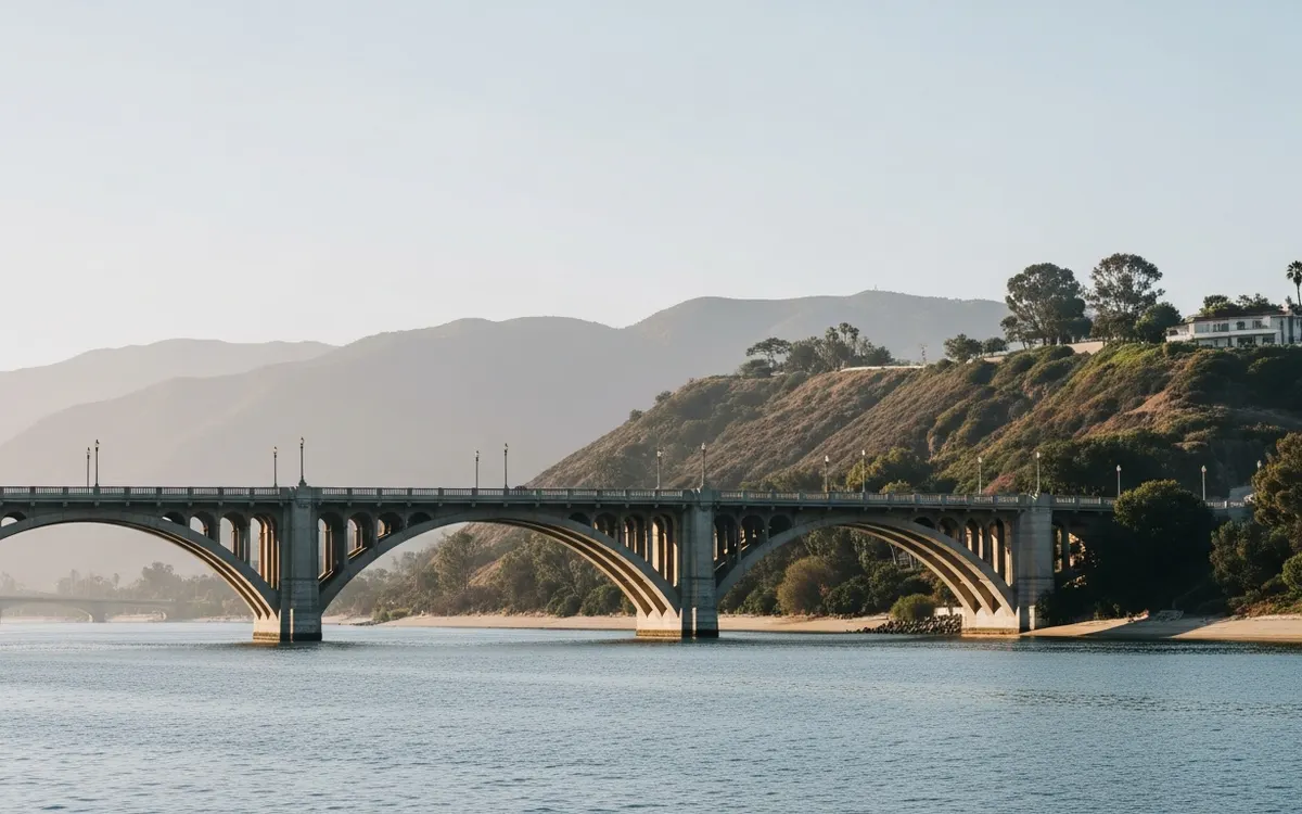 The Colorado Street Bridge and San Gabriel foothills near Pasadena under soft morning light, no people